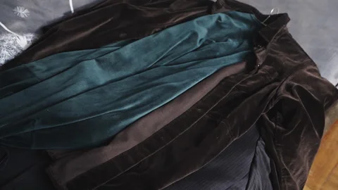 Jackets of Various Designs Thrown Individually onto Bed Wardrobe Clear Out Old 動画素材 337764588