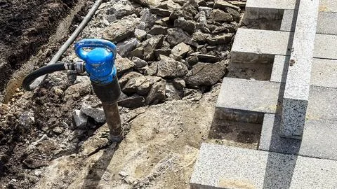 Jackhammer in broken footpath 스톡 사진