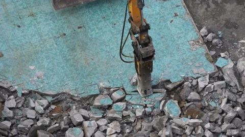 Jackhammer of the excavator breaks the ceramic tile on the asphalt, splits large Stock Footage 136701965