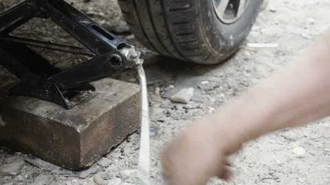 Jacking up the car for wheel repair Stock Footage 156541648