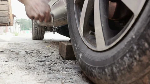 Jacking up the car for wheel repair Stock Footage 156978754