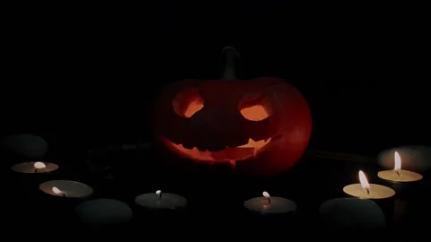 Jack's pumpkin lantern surrounded by candles and snakes - Halloween decoration Stock Footage 140743000
