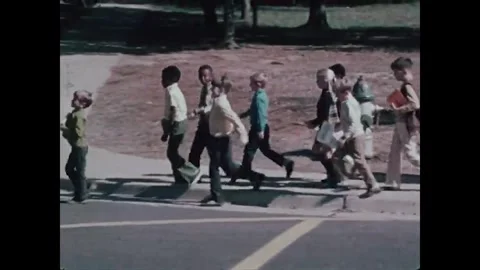 JACKSON - 1970s - A policeman stops traffic at a pedestrian crossing to let Stock Footage 341985542