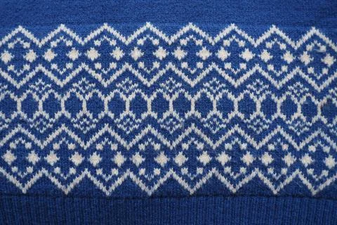 Jacquard knitted pattern. Knitted with white thread rhombuses and zigzags on  写真素材