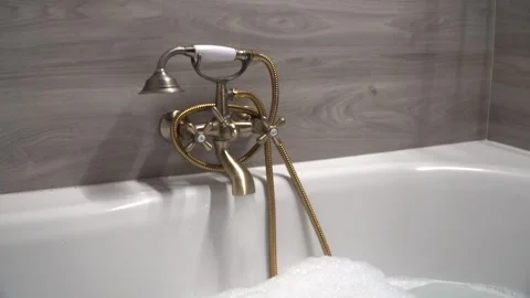 Jacuzzi faucet dropping water to a bubble bathtub Stock Footage 256087863