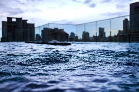 Jacuzzi pool on rooftop of condominium or hotel with city view at twilight Stock Photos