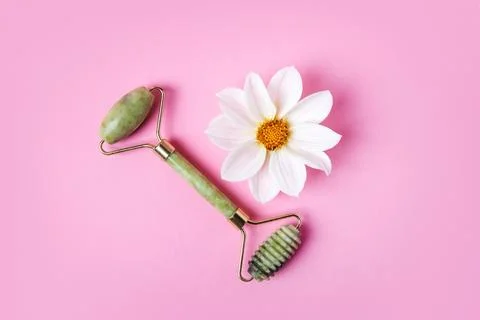 Jade roller and flowers Stock Photos