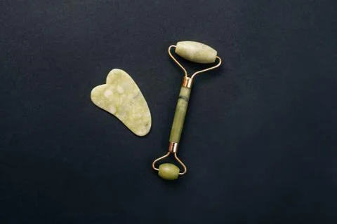 Jade roller and gouache scraper for massage. Stock Photos