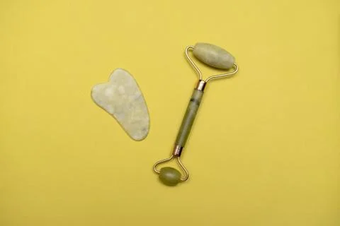 Jade roller and gouache scraper for massage Stock Photos