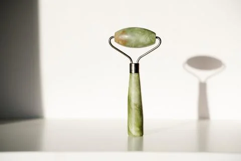 Jade roller on white background Stock Photos