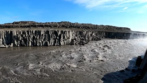 Jagged basalt cliffs and rushing glacial river at Dettifoss waterfall Stock Footage 333516994
