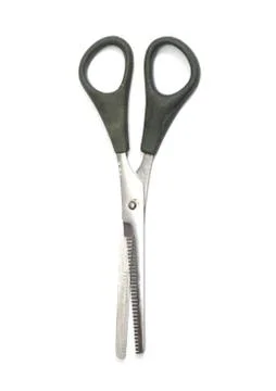 Jagged edges hairdressing scissors. isolated over white Stock Photos