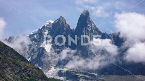 Jagged mountain peak landscape with clouds Stock Photos