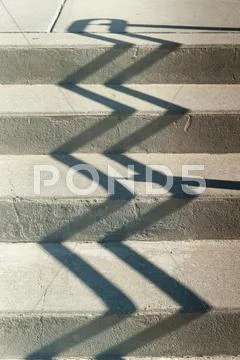 Jagged railing shadow Stock Photos