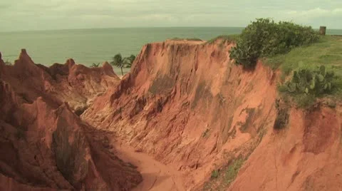 Jagged Red Rock Cliffs Against Ocean Background 5 Video stock 19003832
