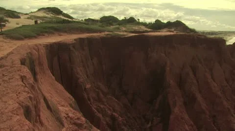 Jagged Red Rock Cliffs Against Ocean Background 3 Stock-Footage 19210165
