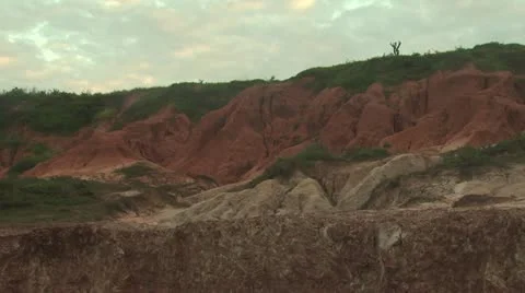 Jagged Red Rock Cliffs With A Cloudy Filled Sky Background Video stock 19210420