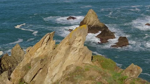 Jagged Rock Pillars Emerging From The Waters At The Coastline Stock Footage 325514787