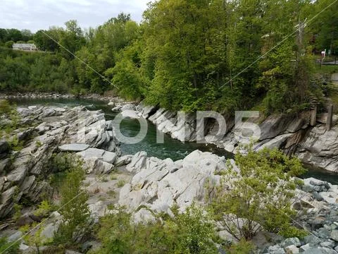 Jagged rocks and water in stream or river Stock Photos