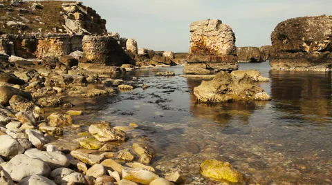 Jagged rocks , the sea and the waves Stock Footage 57395922