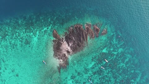 Jagged rocky reef formation rises from clear turquoise water near Phi Phi Stock Footage 342291156