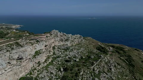 Jagged sea cliffs in Dingli Malta on hazey sky day, aerial dolly tilt down Stock Footage 242761409