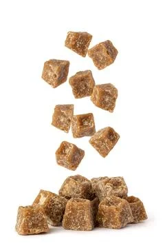 Jaggery falling on white background Stock Photos