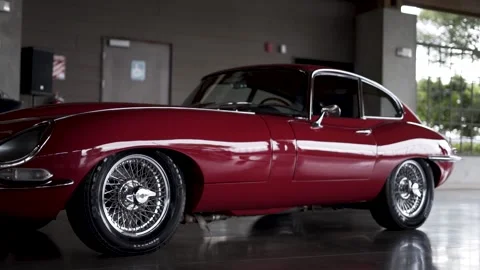 Jaguar E-Type antique english car jagaur red on road on display Video stock 156947883