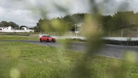 Jaguar i pace orange car on the road Stock Footage 155606366