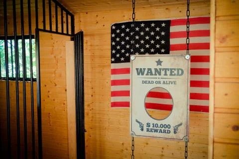 Jail and Wanted Sign in Texas with american flag on the background Stock Photos