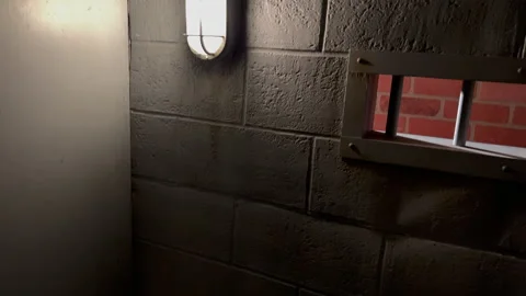 Jail cell bed cage light night cinematic 2 Stock Footage 225236695