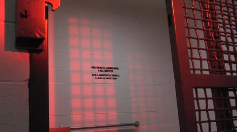 Jail door closes with dramatic red lighting and echo Stock-Footage 22540856