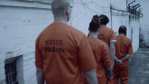 Jail inmates taken to the yard while cuffed Stock Footage 283085933