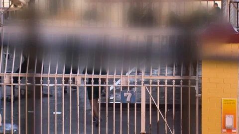 JAIL INMATES TRAINING IN YARD Stock Footage 129206492