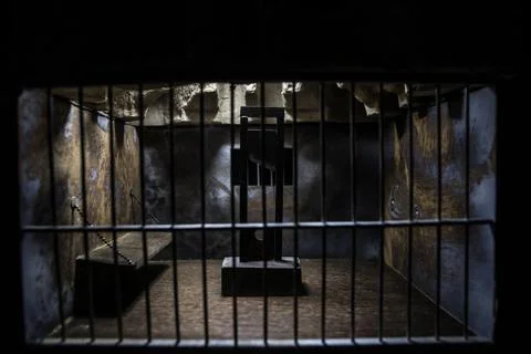 Jail or prison cell. Obsolete gray grunge concrete room. Creative artwork dec Stock Photos