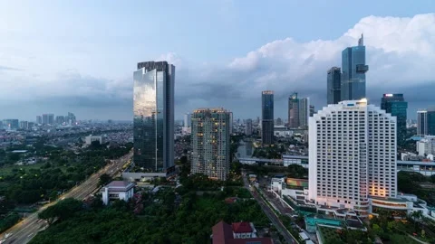 Jakarta, Indonesia: Time lapse of the sun that sets over the modern Jakarta Stock Footage 229390853