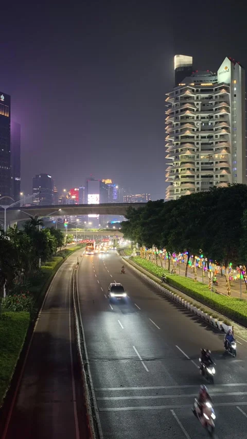Jakarta Night Traffic with Dedicated Bus Rapid Lane and High Rise Building Stock Footage 339166344