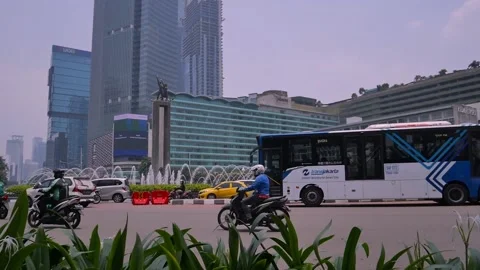 Jakarta traffic at Bundaran HI landmark Stock Footage