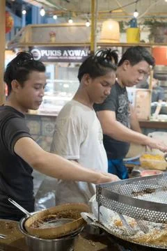 Jakarta,Indonesia. April 23, 2023. Men frying fried Cempedak at Petak 6, Glod Stock Photos