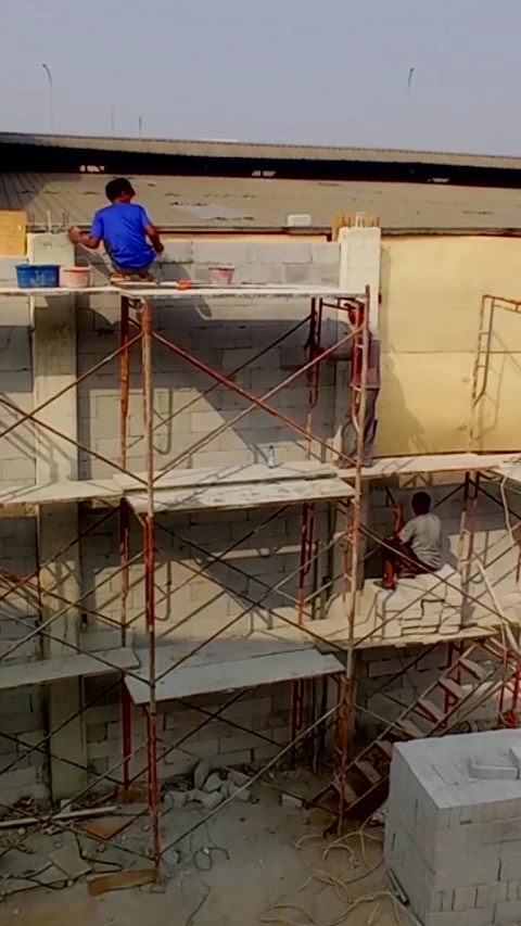 Jakarta,July 27, 2026. Construction workers are working on a wall. Stock Footage 341996170