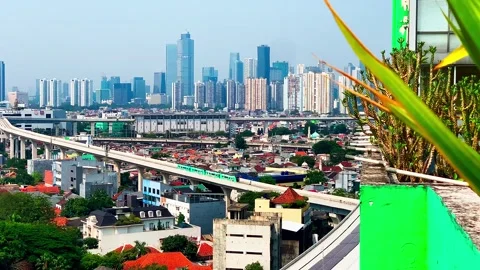 Jakarta's LRT train glides along elevated tracks. Vídeos de archivo 346212849