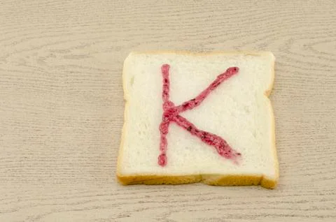 Jam alphabet on sliced bread Stock Photos