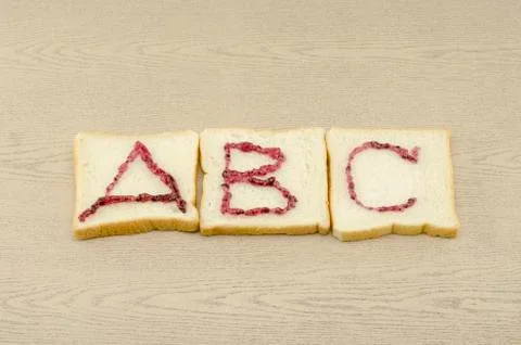 Jam alphabet on sliced bread Stock Photos