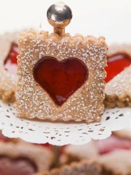 Jam biscuits with icing sugar on a cake stand Stock Photos