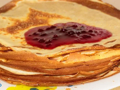Jam flows over pancakes Stock Photos
