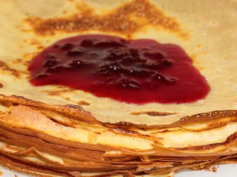 Jam flows over pancakes Stock Photos