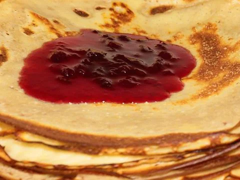 Jam flows over pancakes Stock Photos