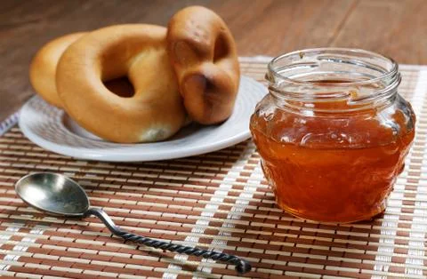 Jam jar and pretzel on the table close-up Stock Photos