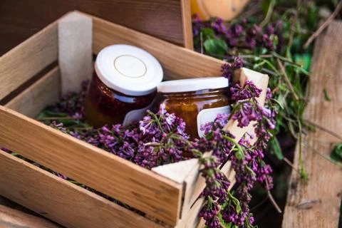 Jam jars in a box with lilacs Stock Photos