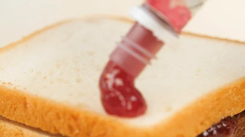 Jam on a piece of bread Stock Footage 89968466
